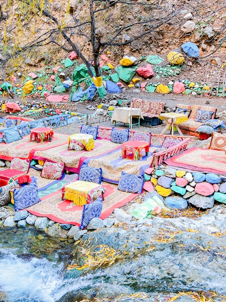 Colorful seating area by a stream in Setti Fadma, Ourika Valley, Morocco.