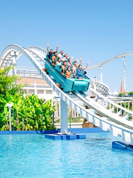 Roller coaster ride at The Land of Legends with people enjoying the descent into water.