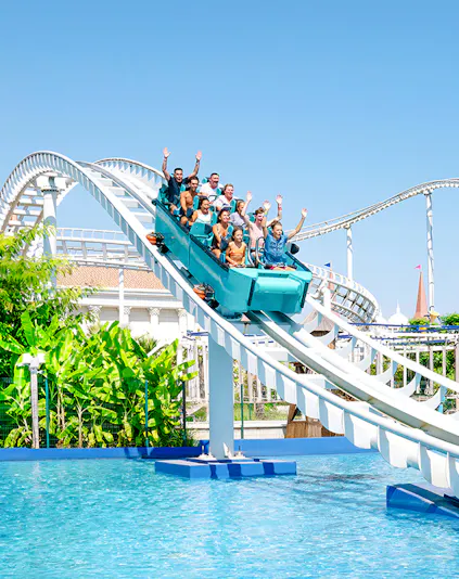 Roller coaster ride at The Land of Legends with people enjoying the descent into water.