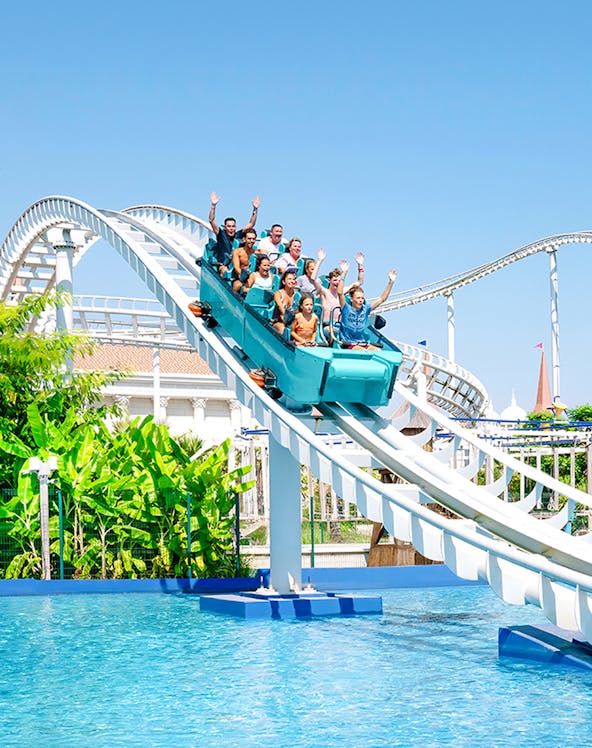 Roller coaster ride at The Land of Legends with people enjoying the descent into water.