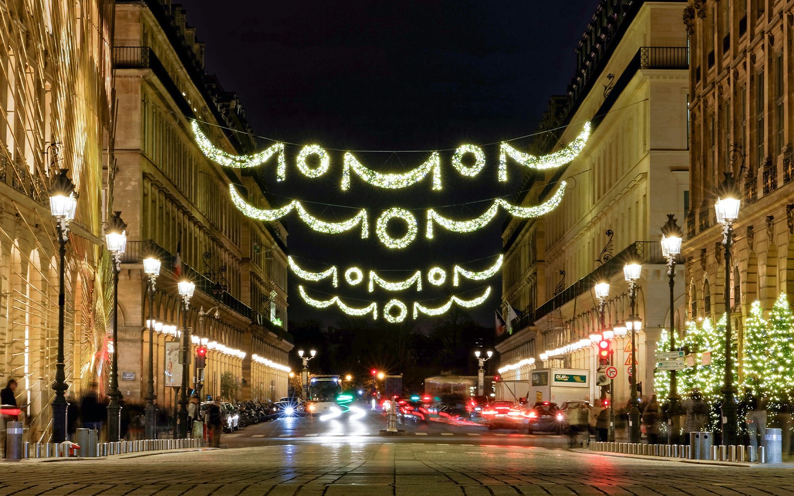 Paris streets adorned with festive Christmas lights during a Tootbus holiday tour.