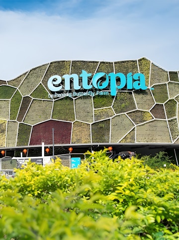 Entopia by Penang Butterfly Farm entrance with green wall and foliage.