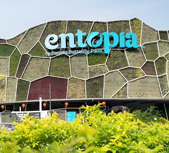 Entopia by Penang Butterfly Farm entrance with green wall and foliage.