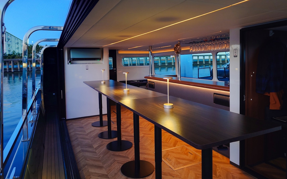 Modern cruise interior with bar setup on Meguro River, Tokyo.