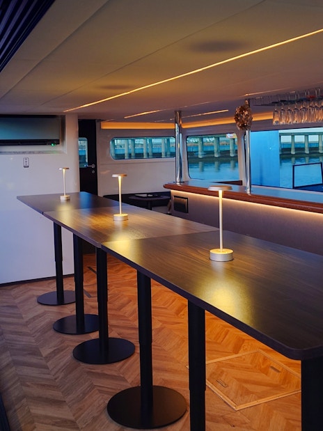 Modern cruise interior with bar setup on Meguro River, Tokyo.