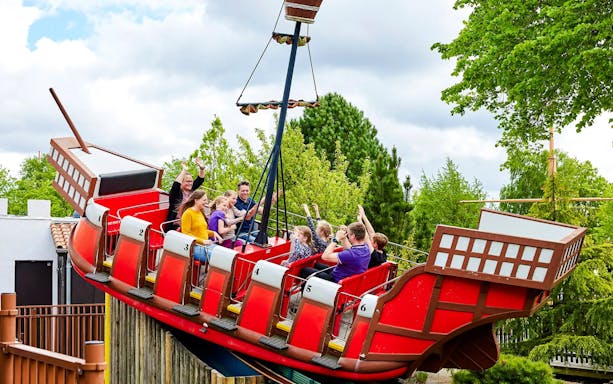 Guests on a swinging pirate ship ride at LEGOLAND Billund.