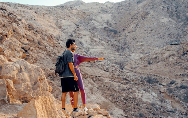 Visitors exploring rocky terrain at Mleiha Archaeology Centre during Sounds of the Past Tour.