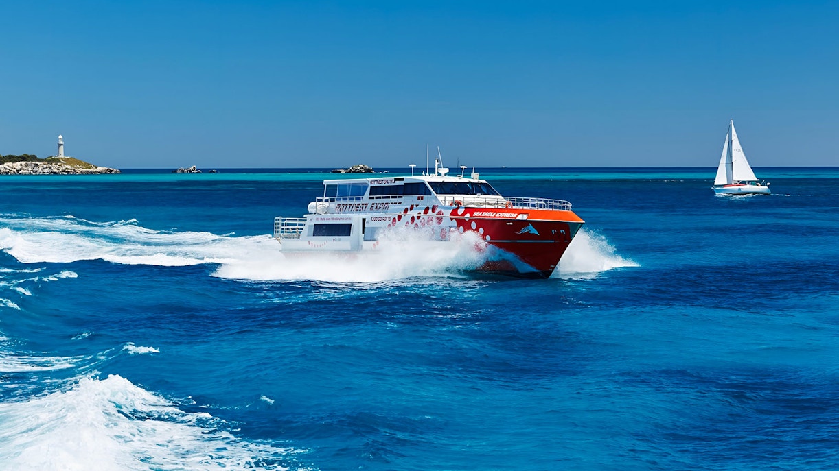 Ferry approaching Rottnest Island with clear blue waters, part of return transfers from Perth or Fremantle.