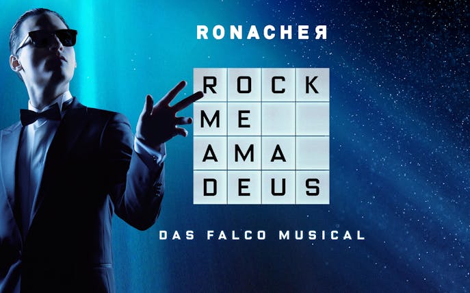 Performer in sunglasses and tuxedo with 'Rock Me Amadeus - Das Falco Musical' text at Ronacher