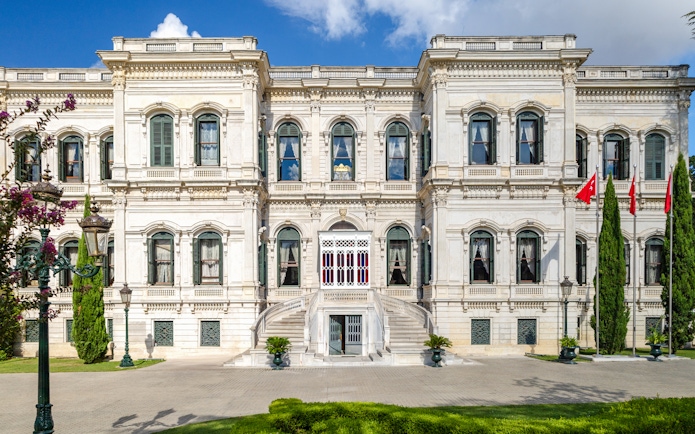 Exterior of Yıldız Palace with ornate windows and Turkish flags, Istanbul.