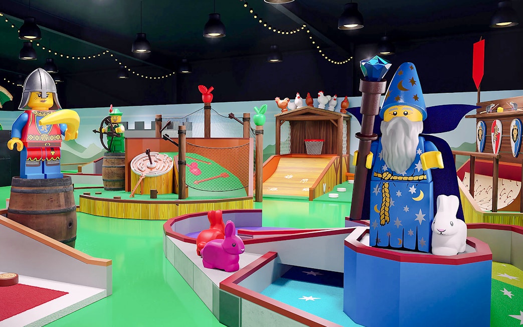 Medieval-themed mini golf course at LEGOLAND® Adventure Golf with wizard and knight LEGO figures.