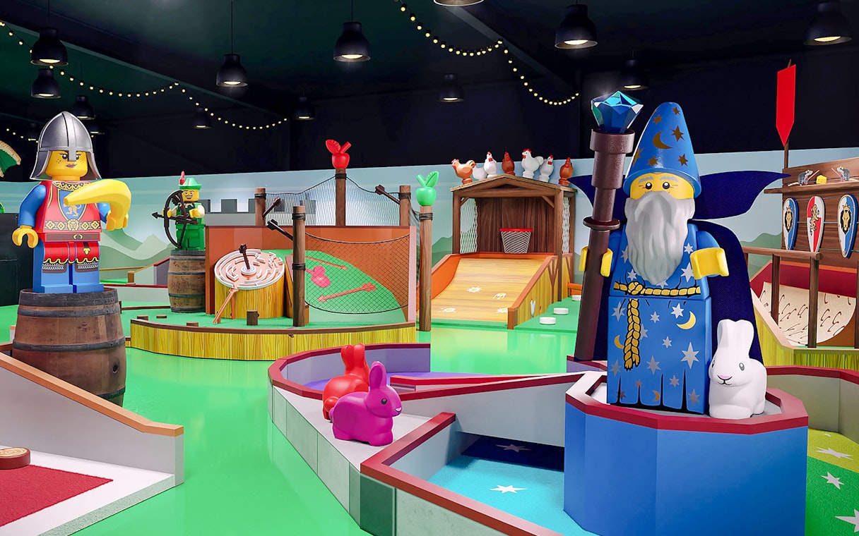 Medieval-themed mini golf course at LEGOLAND® Adventure Golf with wizard and knight LEGO figures.