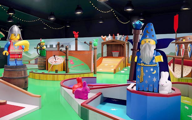 LEGOLAND® Adventure Golf medieval-themed mini golf course with castle and dragon sculptures.