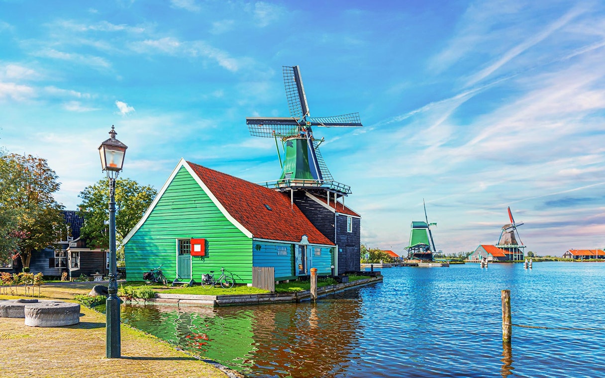 Windmill and green house by the water in Zaanse Schans, Netherlands.