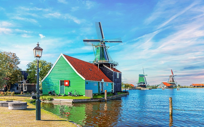 Windmill and green house by the water in Zaanse Schans, Netherlands.