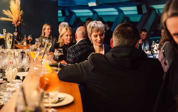 People socializing at the bar in Berlin TV Tower.