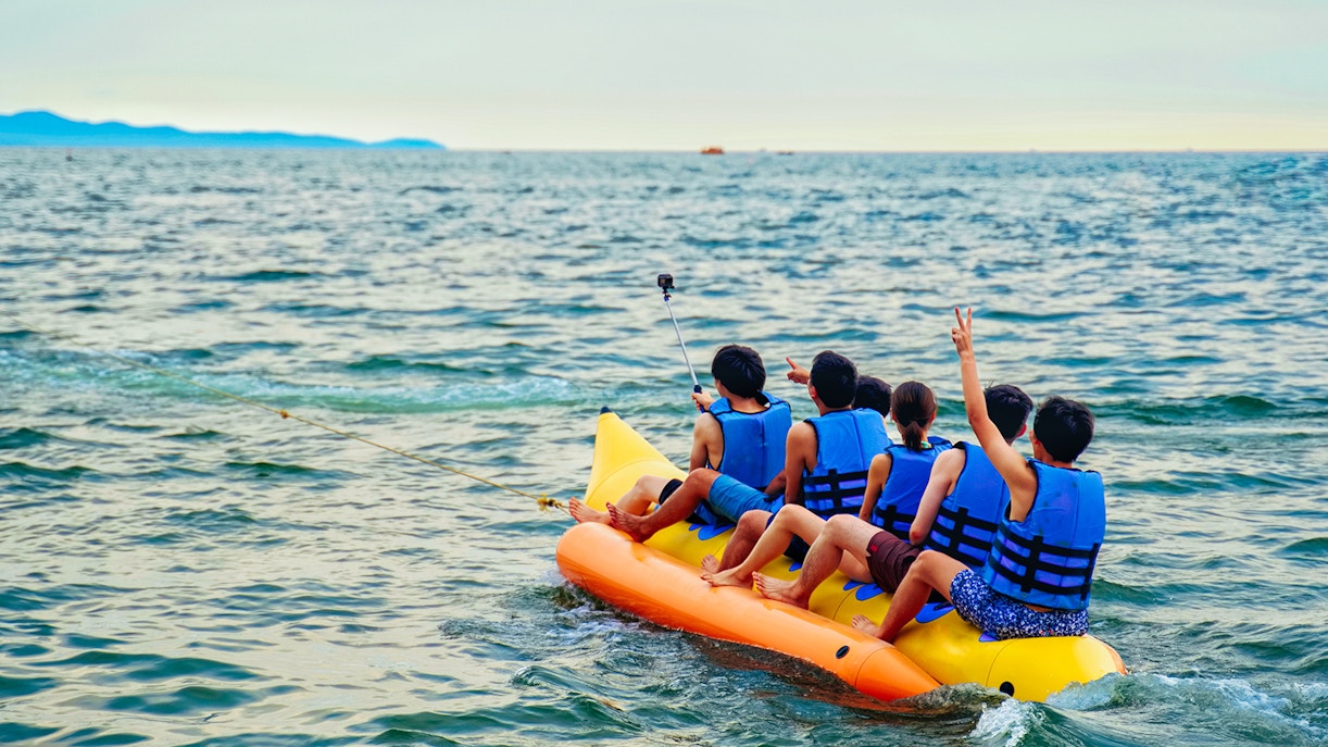 Group enjoying a banana boat ride on the ocean.