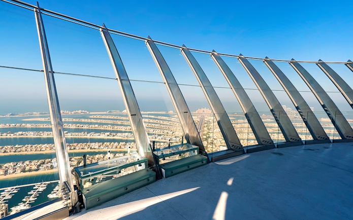 Observation deck view of Palm Jumeirah, Dubai, with ocean and skyline in the background.