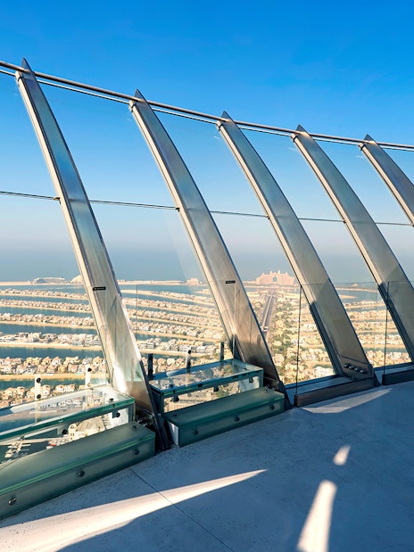Observation deck view of Palm Jumeirah, Dubai, with ocean and skyline in the background.