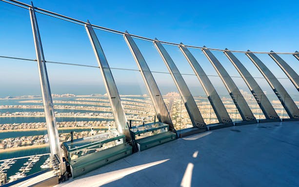 Observation deck view of Palm Jumeirah, Dubai, with ocean and skyline in the background.