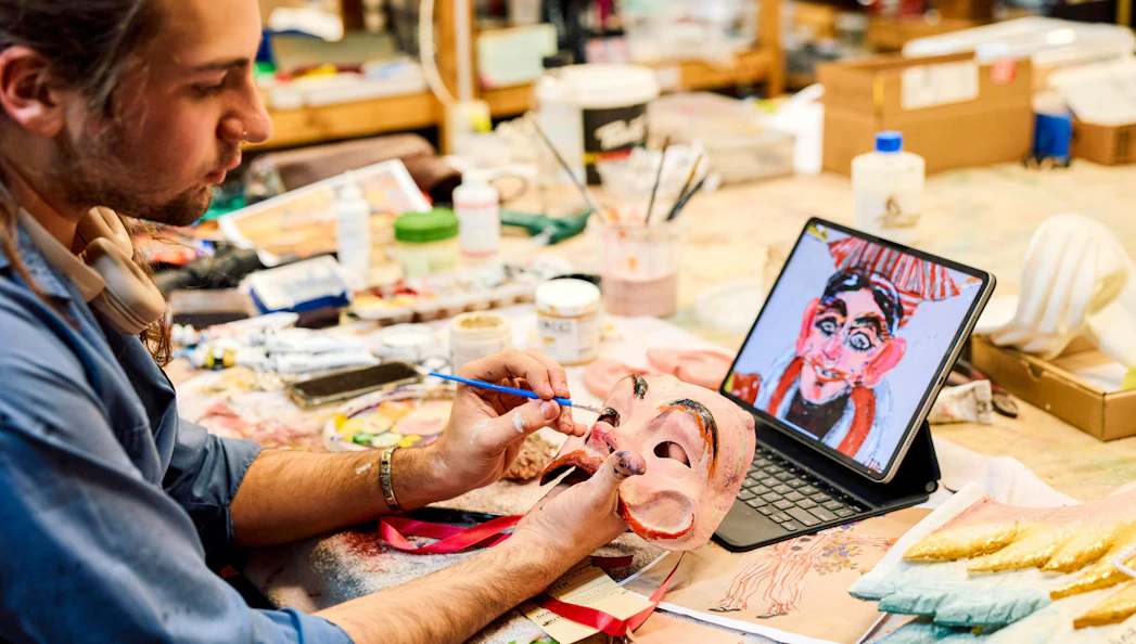 Craftsman painting opera mask for La Boheme in Sydney workshop.