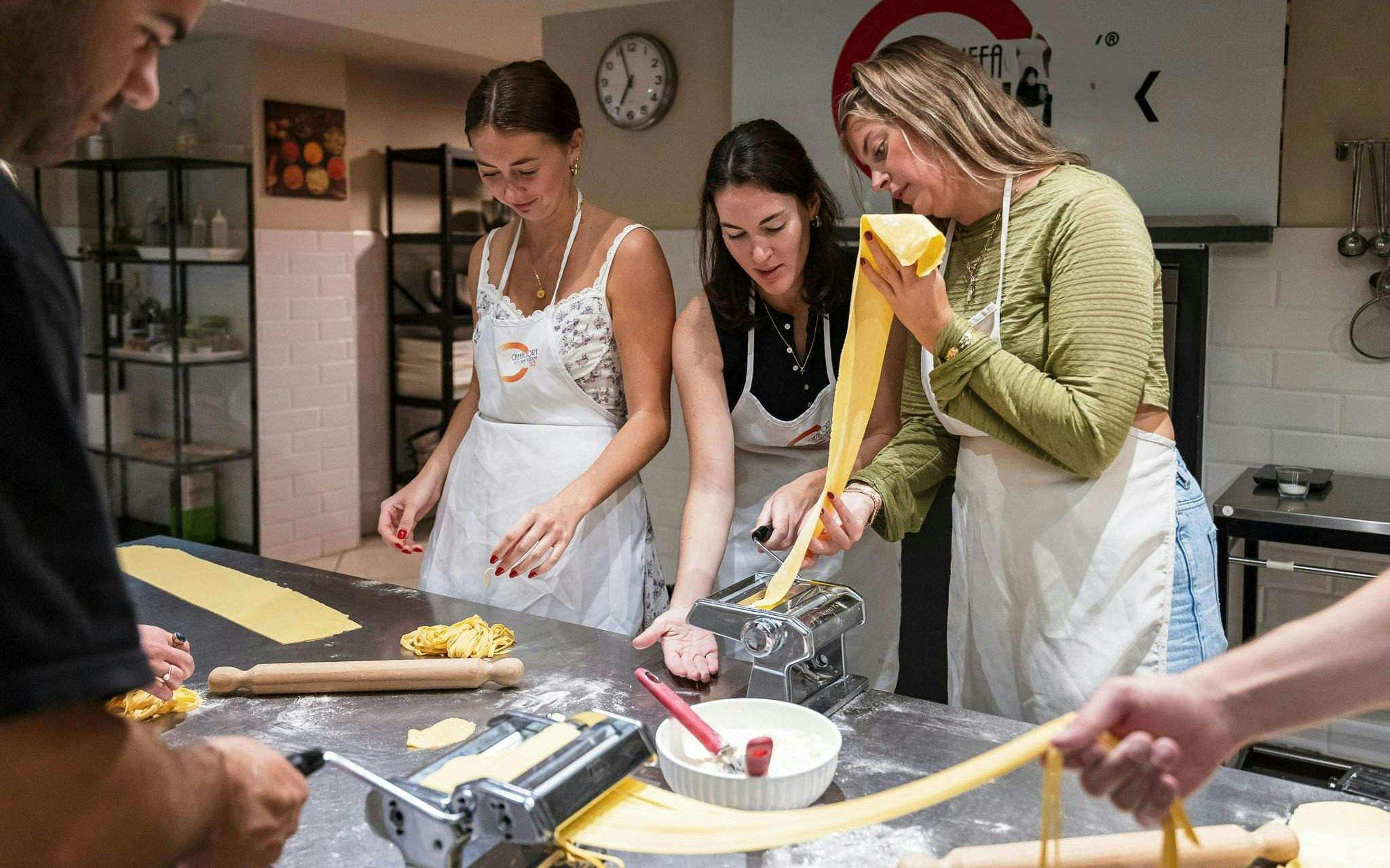 Small group making pasta in a cooking class in Florence.