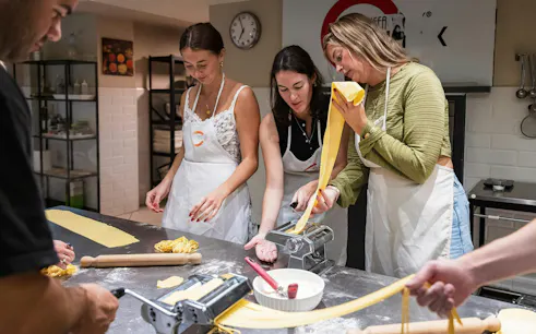 Small group making pasta in a cooking class in Florence.