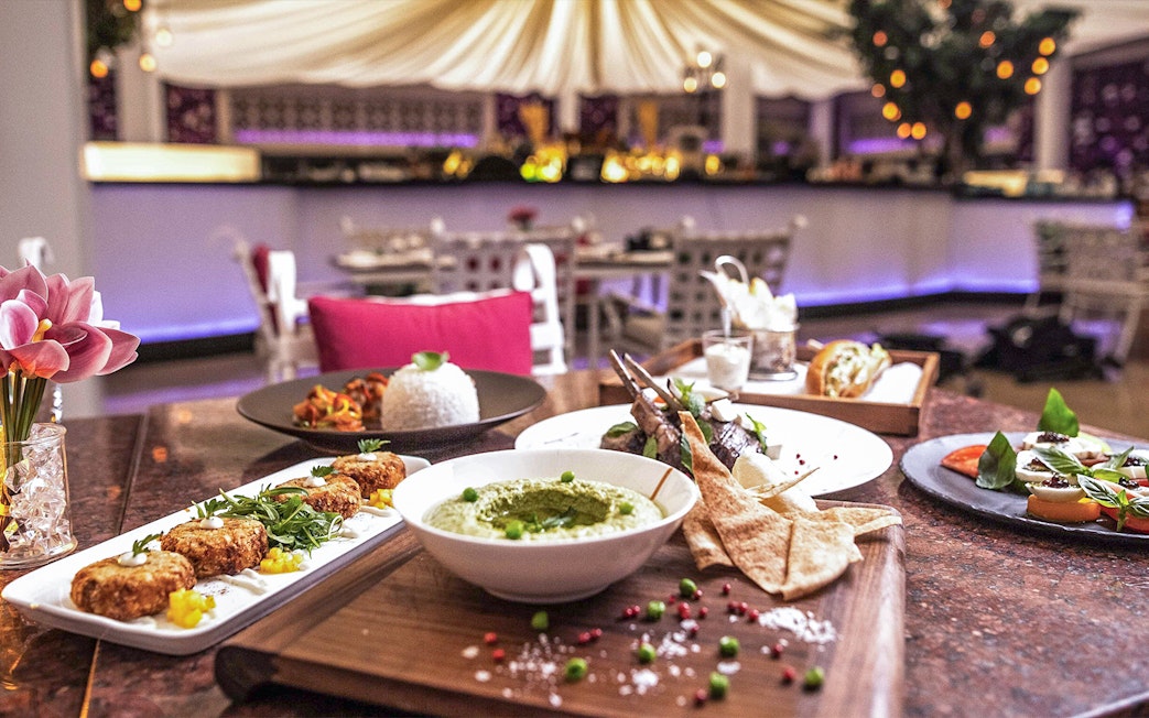 La Perle By Dragone dinner at Le Patio Restaurant with diverse gourmet dishes.