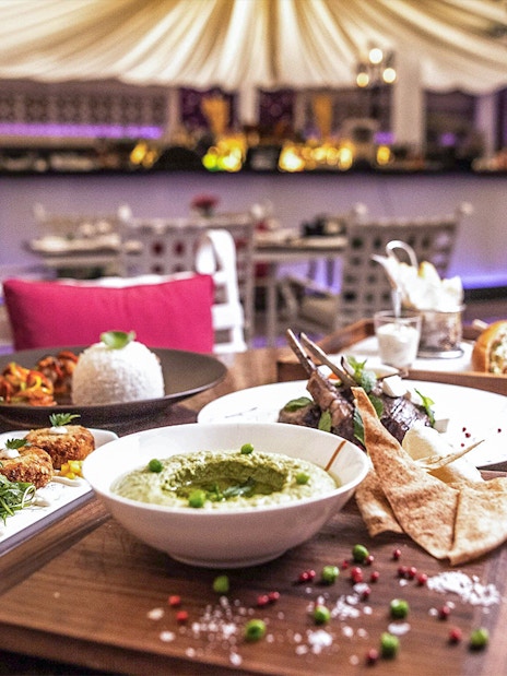 La Perle By Dragone dinner at Le Patio Restaurant with diverse gourmet dishes.