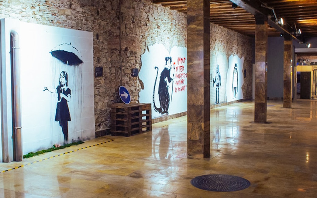 Banksy artworks on display at the Banksy Museum in Barcelona, featuring iconic street art.
