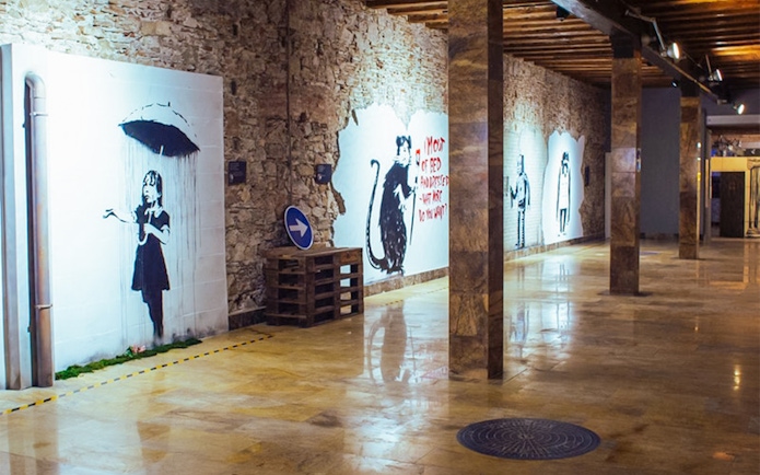 Banksy artworks on display at the Banksy Museum in Barcelona, featuring iconic street art.