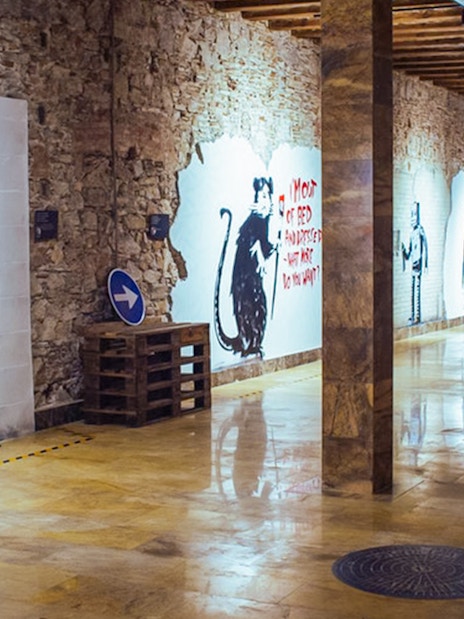 Banksy artworks on display at the Banksy Museum in Barcelona, featuring iconic street art.