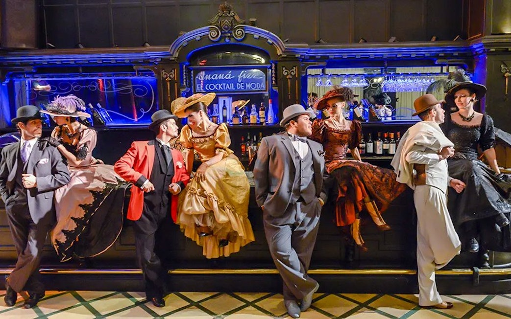 Tango dancers in vintage attire at El Querandí Tango Show, Buenos Aires.