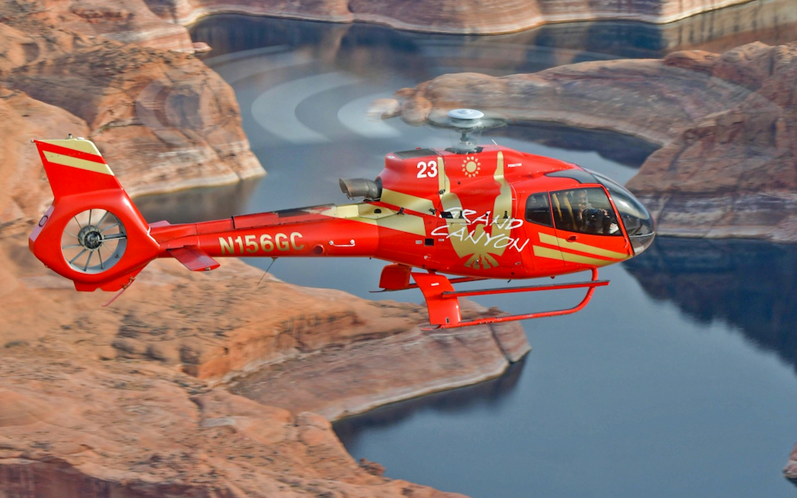 Helicopter flying over the Grand Canyon West Rim with scenic views.
