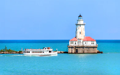 Cruise boat near Chicago Harbor Lighthouse on Lake Michigan.
