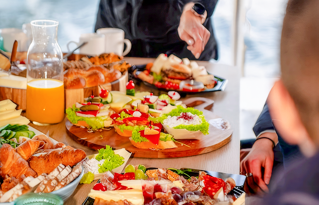 Breakfast spread with pastries, cheese, and juice on Sopot Cruise tour.