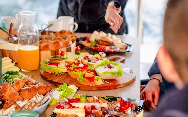 Breakfast spread with pastries, cheese, and juice on Sopot Cruise tour.