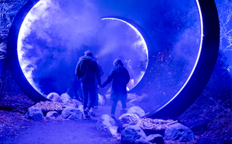 Visitors walking through illuminated portal at Astra Lumina, Currumbin Wildlife Sanctuary.