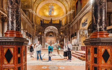 Visitors exploring St. Mark's Basilica interior during exclusive after-hours tour in Venice.