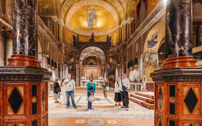 Visitors exploring St. Mark's Basilica interior during exclusive after-hours tour in Venice.