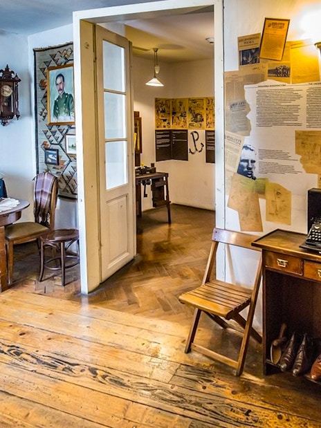 Exhibit room inside Oskar Schindler's Factory with typewriter and historical documents.