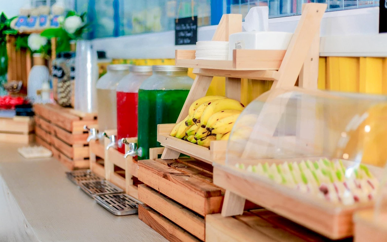 Buffet with bananas, drinks, and assorted food items in Phuket.