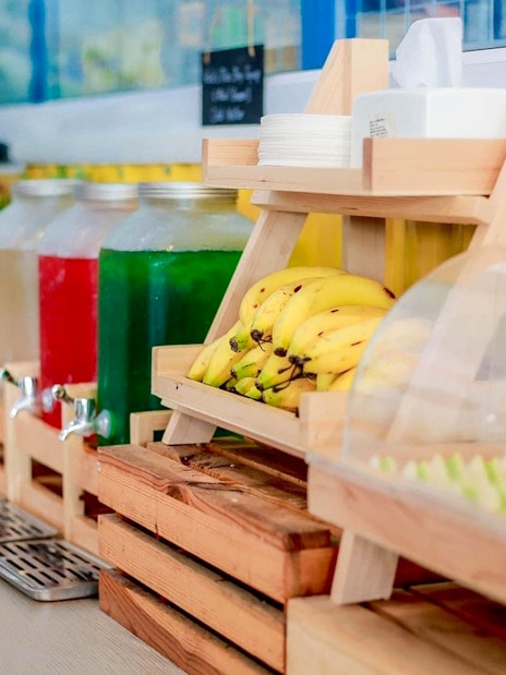 Buffet with bananas, drinks, and assorted food items in Phuket.