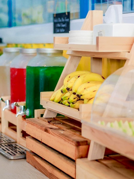 Buffet with bananas, drinks, and assorted food items in Phuket.