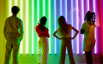 Guests viewing neon light display at Twist Museum, London.