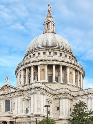 St Paul's Cathedral dome in London against a blue sky.