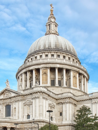 St Paul's Cathedral dome in London against a blue sky.