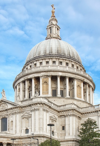 St Paul's Cathedral dome in London against a blue sky.