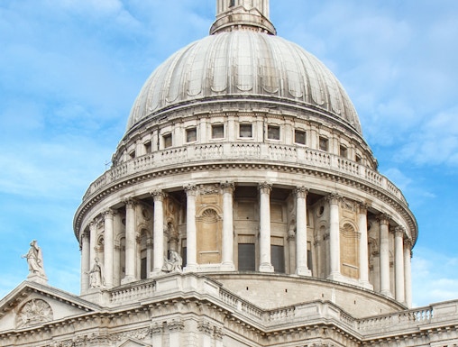 St Paul's Cathedral dome in London against a blue sky.