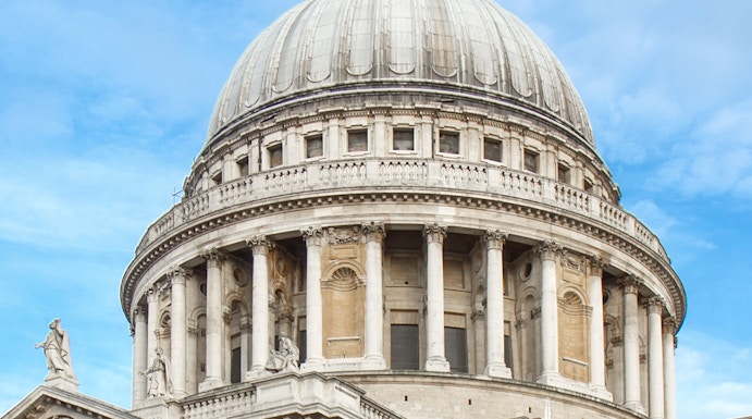 St Paul's Cathedral dome in London against a blue sky.
